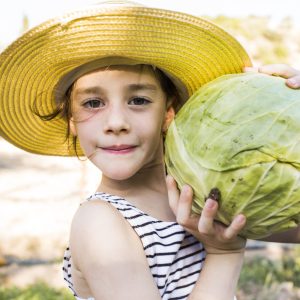 portrait-girl-holding-harvested-cabbage